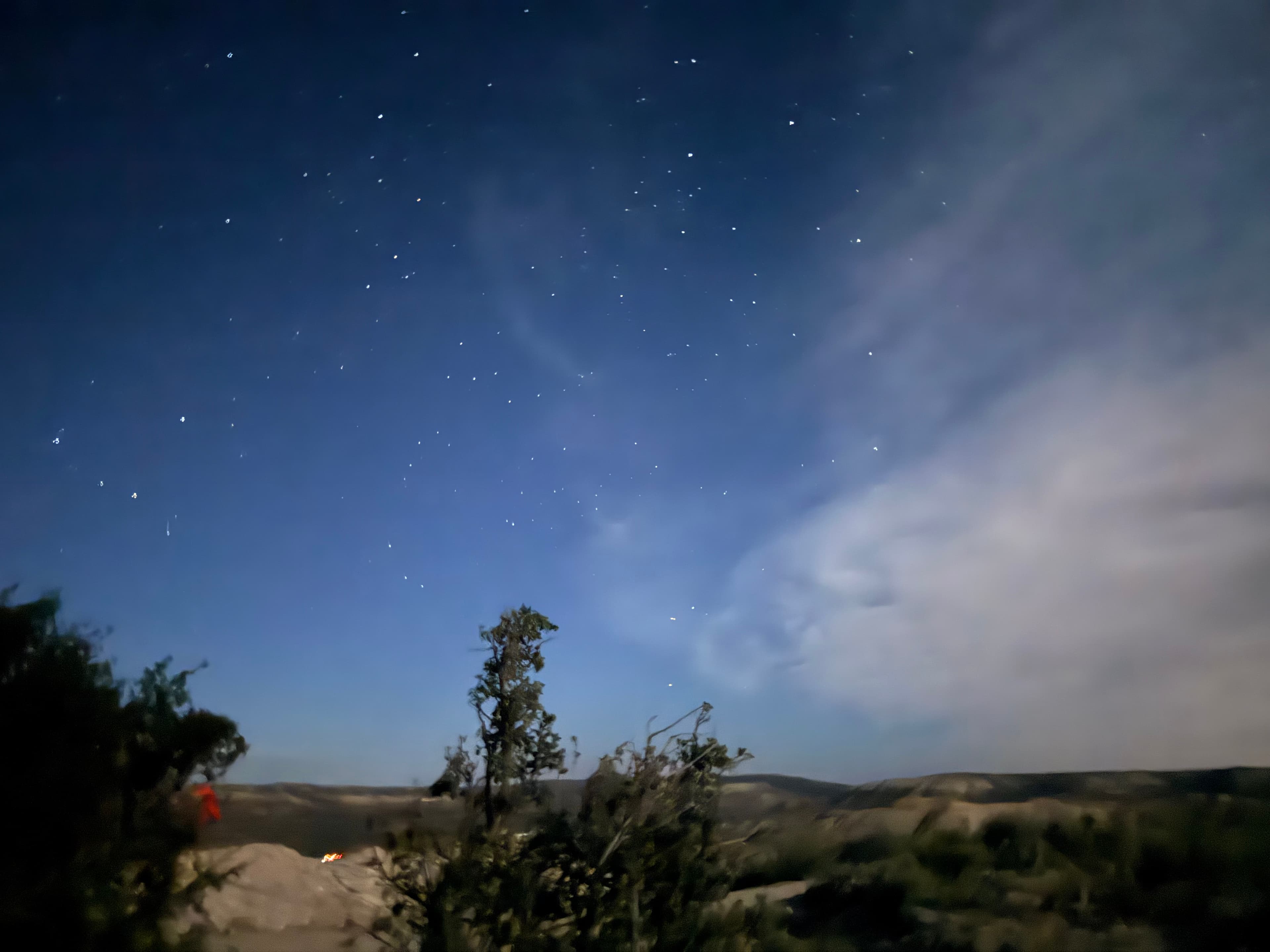 Stars and clouds over the Wyoming dig site at night.