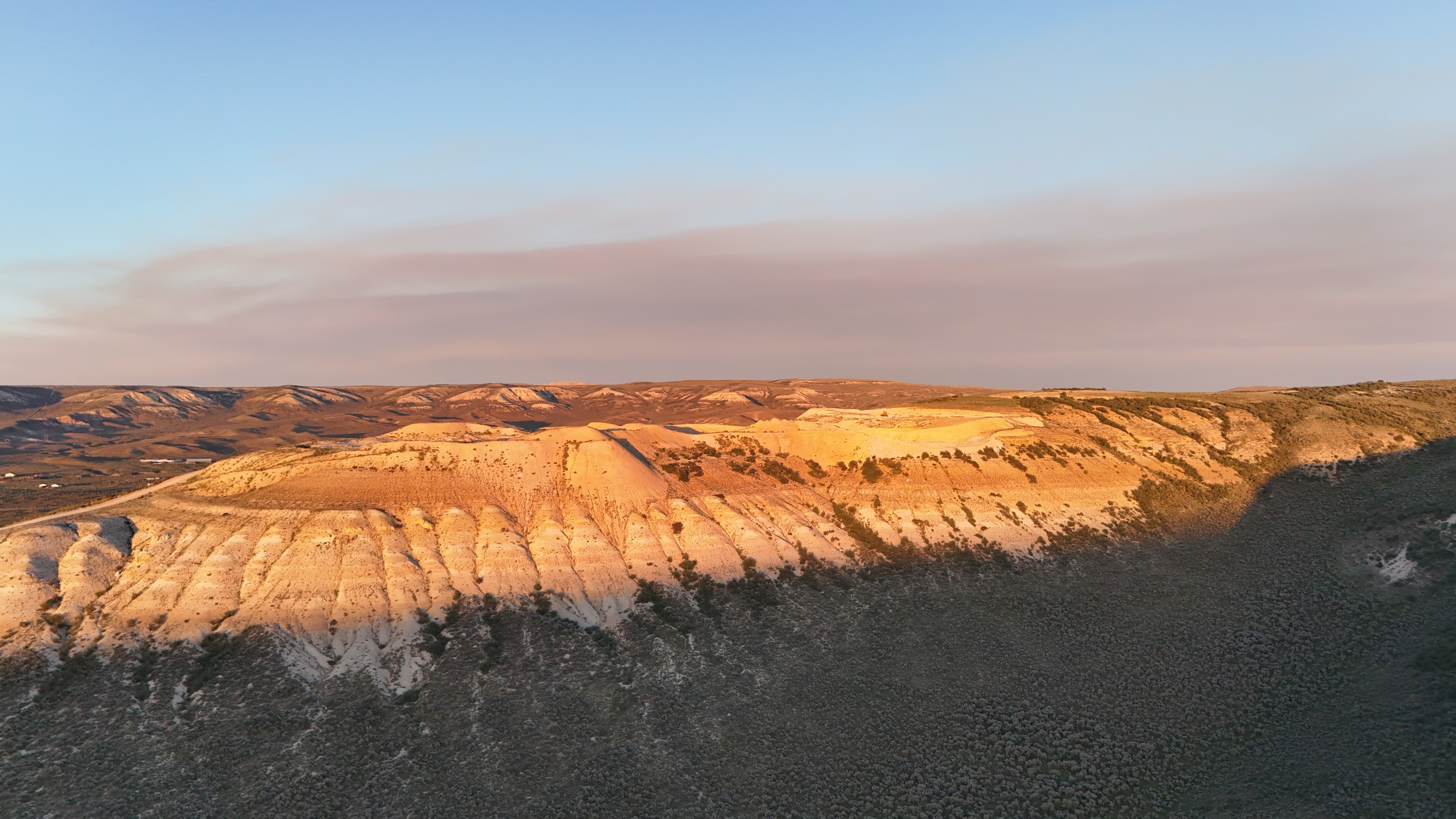 Golden hour light on the quarry hills and scrubland.