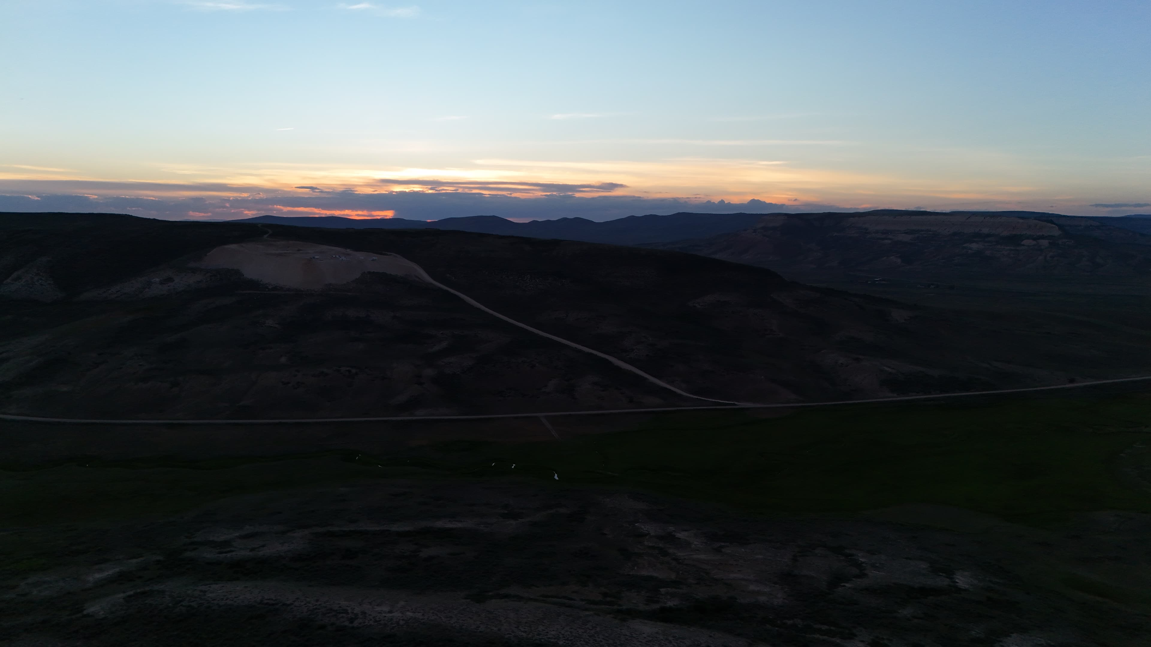 Dusk settles over the Wyoming hills and quarry site.