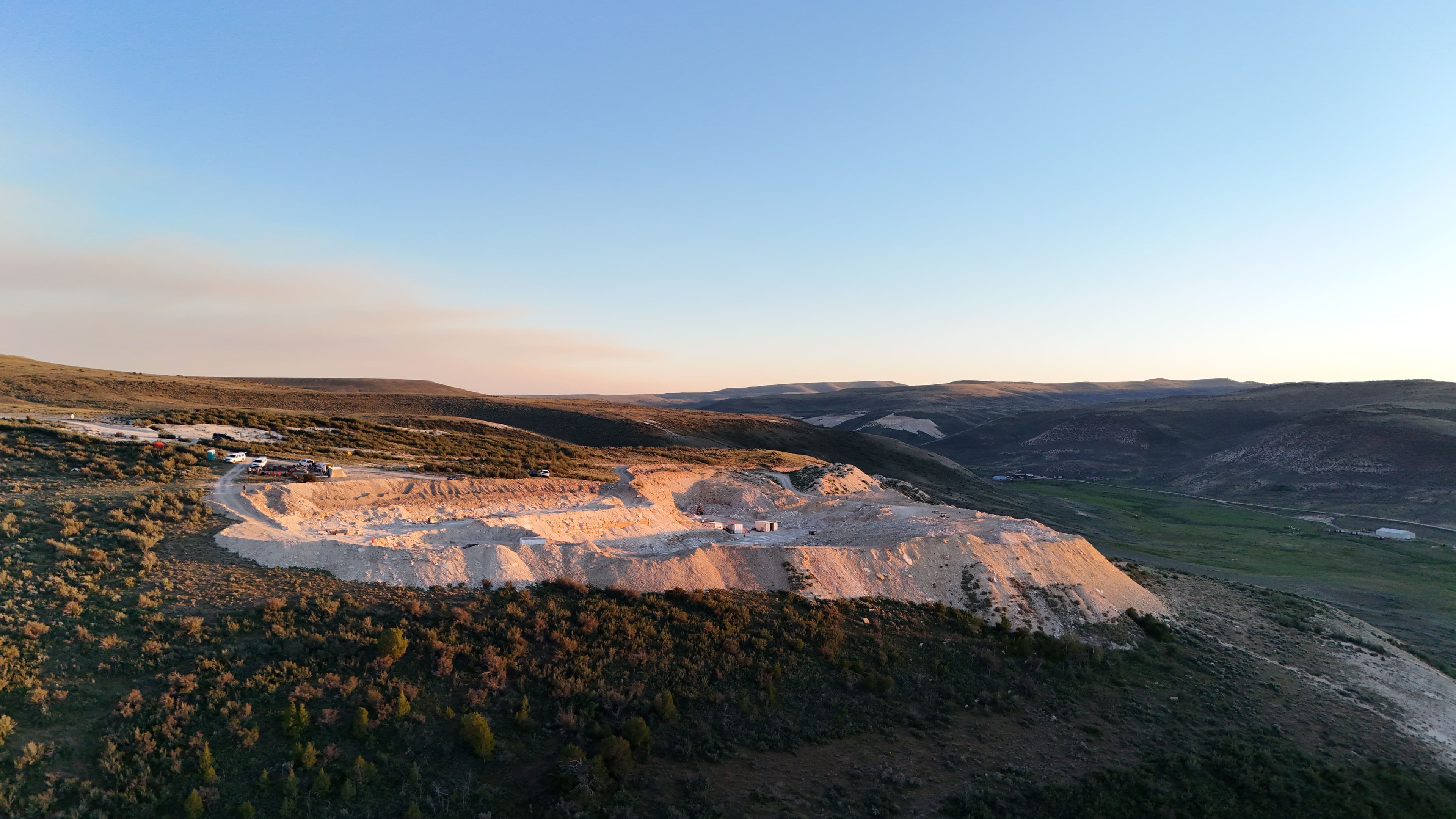 Aerial view of a hillside excavation at golden hour